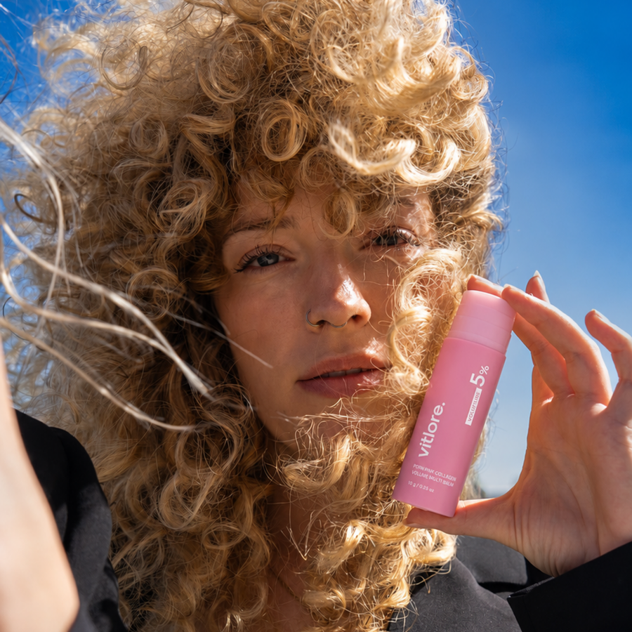 Woman holding the Vitlore PDRN Pink Collagen Volume Multi Balm stick